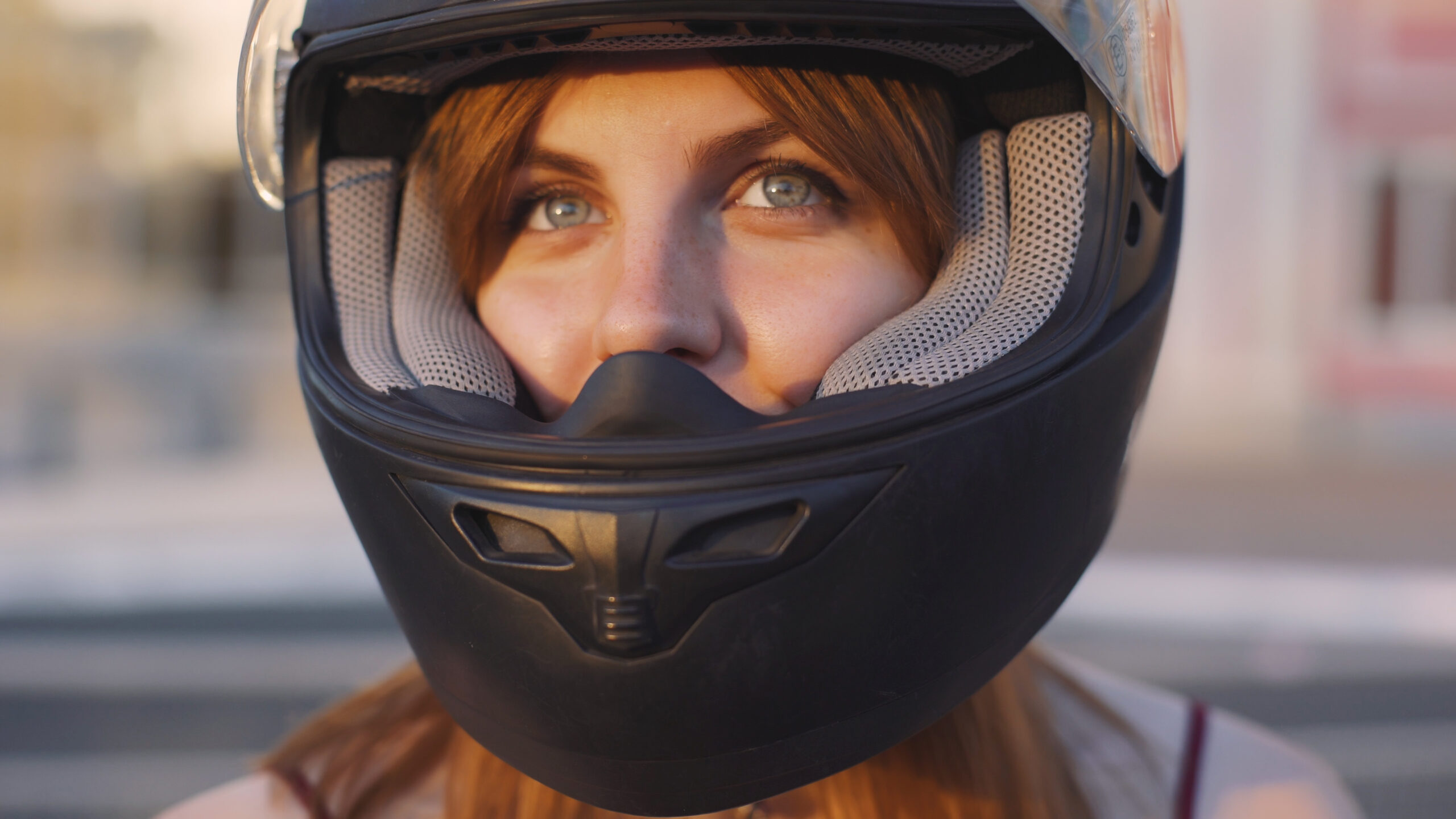 woman motorcyclist with black motorcycle helmet